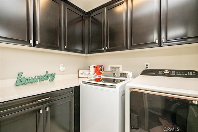 washroom featuring separate washer and dryer and cabinet space
