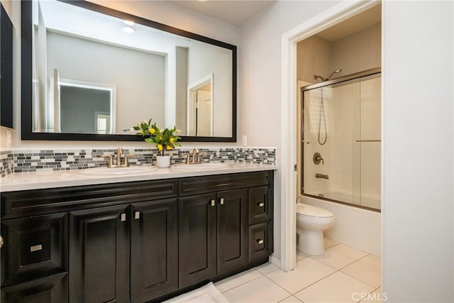 full bathroom with toilet, decorative backsplash, a sink, and tile patterned flooring