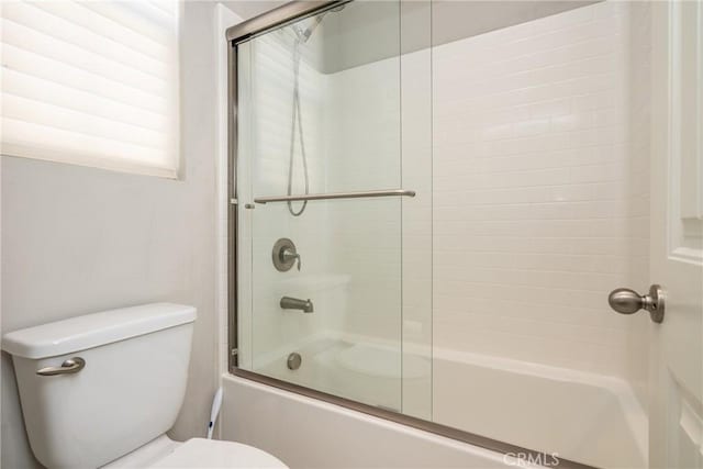 full bath with enclosed tub / shower combo and toilet
