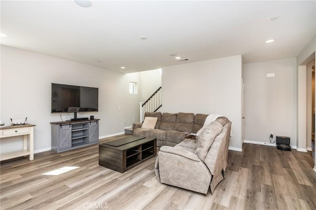living room featuring recessed lighting, baseboards, stairs, and wood finished floors