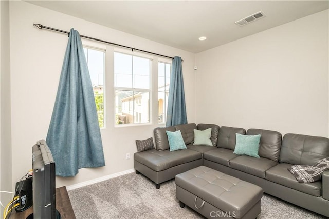 carpeted living room featuring baseboards, recessed lighting, and visible vents