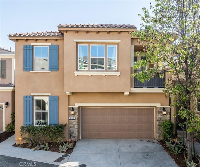 view of property with a garage, stucco siding, and driveway