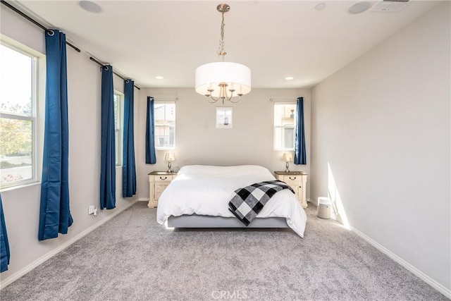 carpeted bedroom featuring baseboards, recessed lighting, and a chandelier