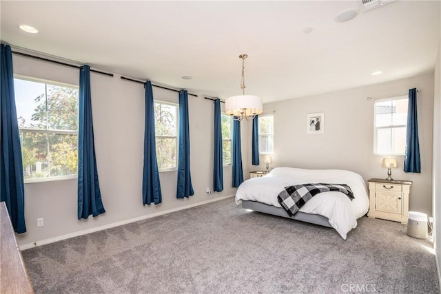 bedroom featuring carpet flooring, a notable chandelier, and multiple windows