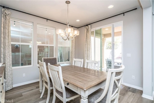dining room featuring light wood-style floors, baseboards, recessed lighting, and a notable chandelier