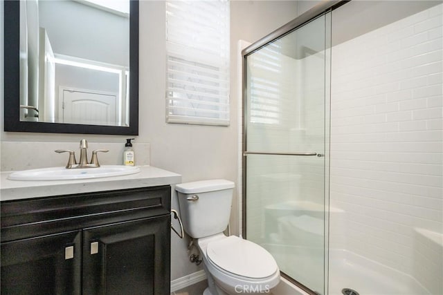 full bath with vanity, toilet, and a stall shower