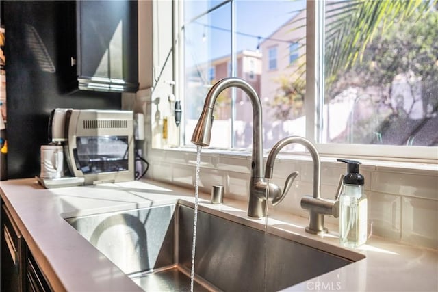 room details with a sink and tasteful backsplash
