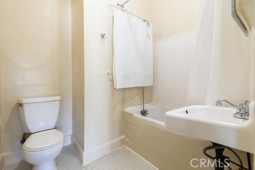 432 N Virgil Ave, Los Angeles, CA 90004 - bathroom featuring a tub, tile patterned flooring, baseboards, toilet, and a shower with shower curtain