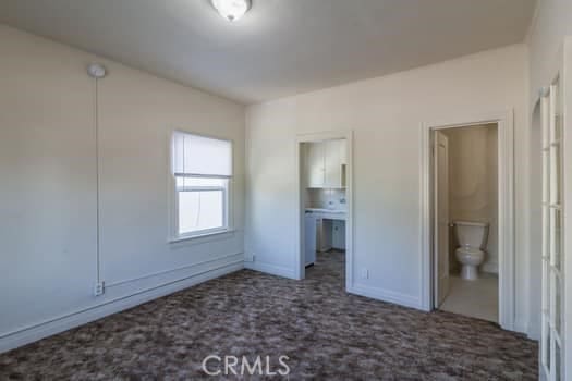 432 N Virgil Ave, Los Angeles, CA 90004 - unfurnished bedroom with ensuite bathroom, carpet, and baseboards