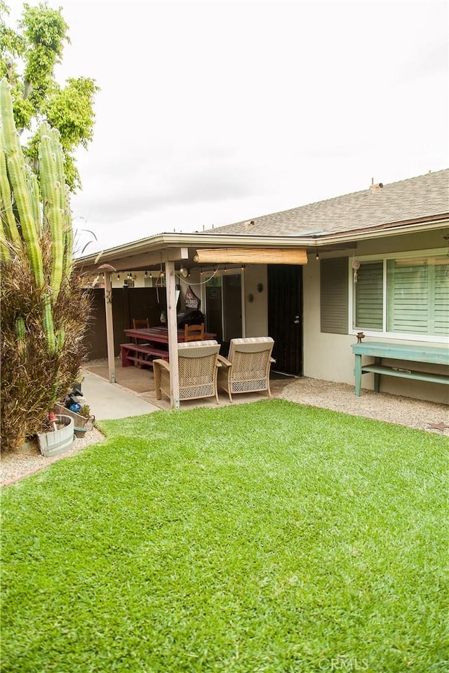 3139 E Chapman Ave Unit 14A, Orange, CA 92869 - rear view of house with a patio, an outdoor living space, a lawn, and stucco siding