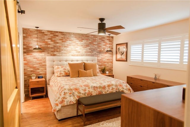 3139 E Chapman Ave Unit 14A, Orange, CA 92869 - bedroom featuring brick wall, light wood-type flooring, and a ceiling fan