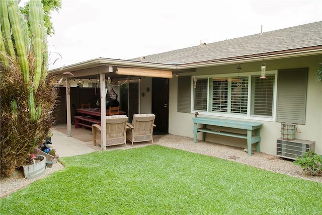 3139 E Chapman Ave Unit 14A, Orange, CA 92869 - rear view of house featuring a lawn, a patio, stucco siding, and roof with shingles