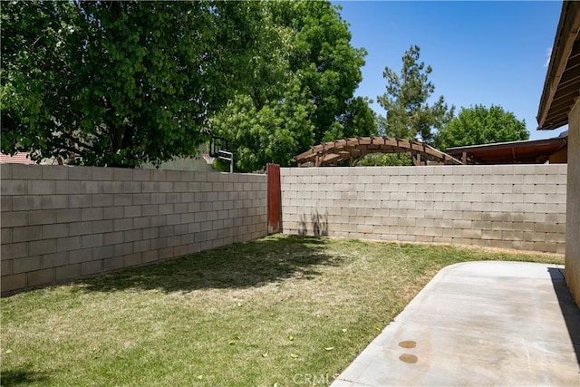 view of yard with a fenced backyard and a patio area