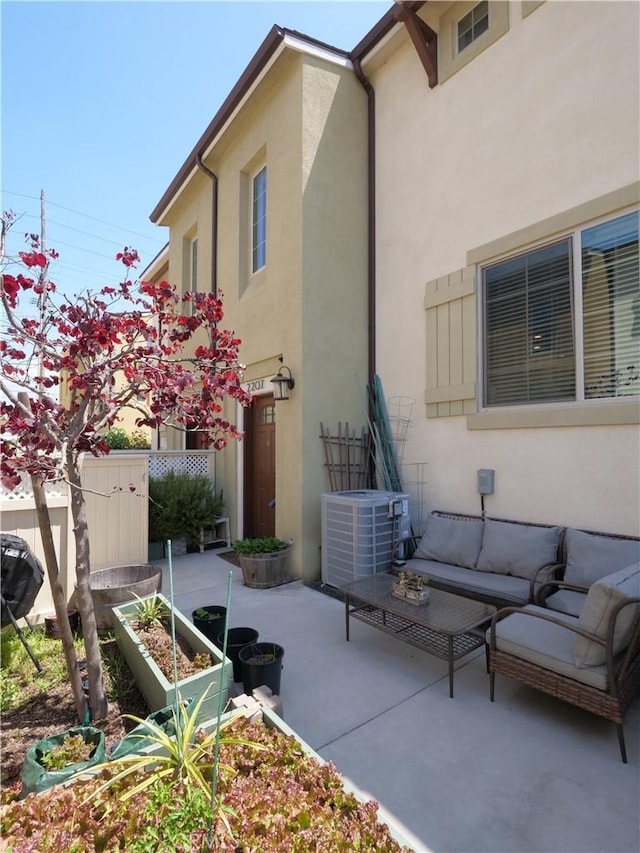 exterior space featuring fence, an outdoor living space, and central AC unit