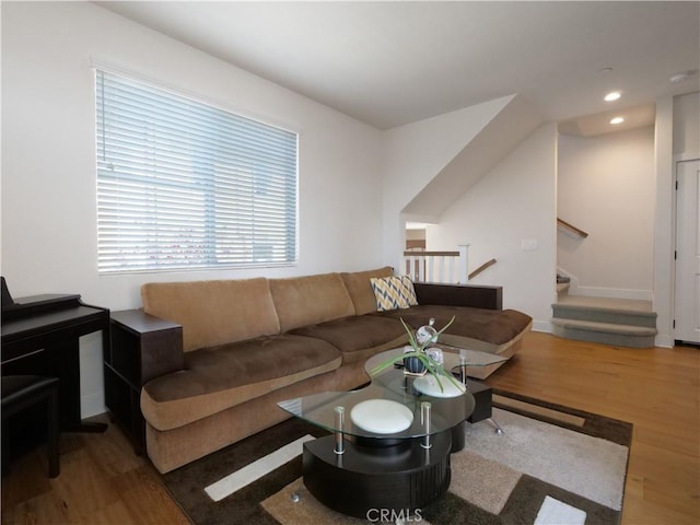 living room featuring recessed lighting, baseboards, and wood finished floors