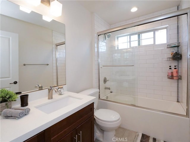 full bathroom featuring vanity, enclosed tub / shower combo, tile patterned floors, and toilet