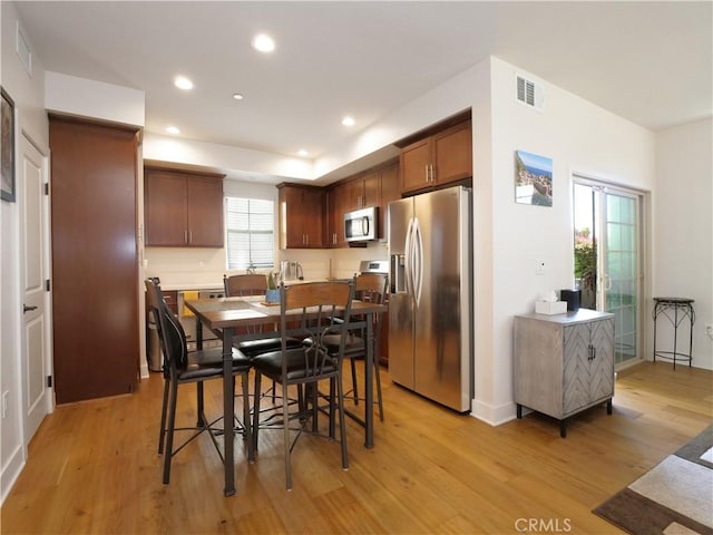 dining area featuring recessed lighting, visible vents, and light wood finished floors