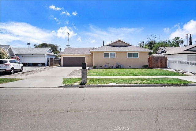 ranch-style house with a garage, fence, a front yard, stucco siding, and concrete driveway