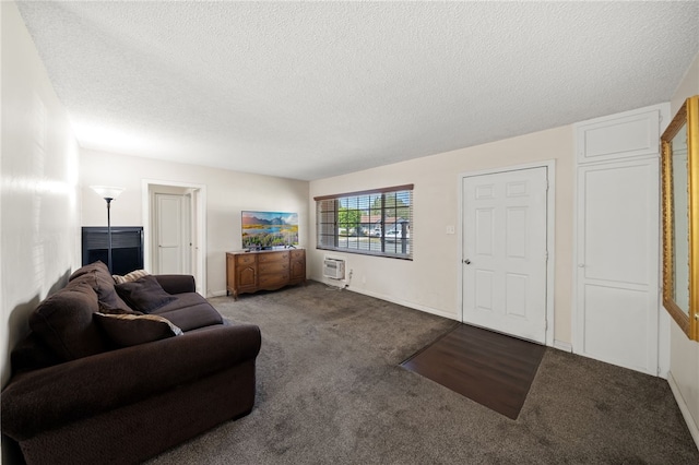 living room featuring a wall mounted AC, carpet flooring, and a textured ceiling
