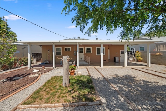 back of property featuring fence, a patio, and stucco siding