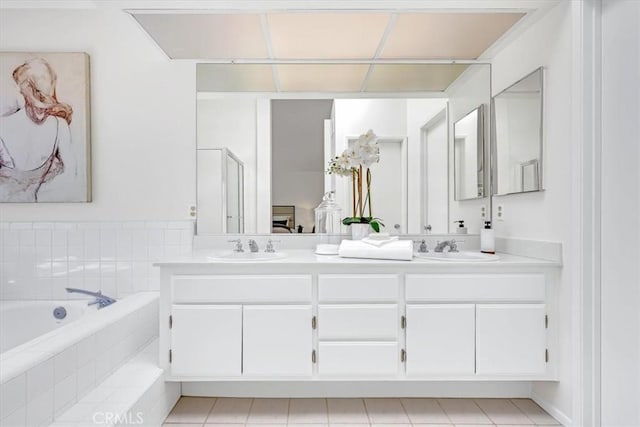 bathroom featuring an enclosed shower, double vanity, a sink, and a bath