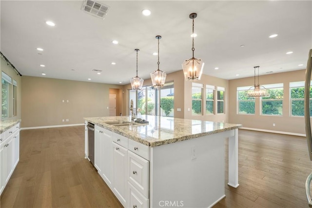 kitchen featuring a sink, baseboards, recessed lighting, and visible vents