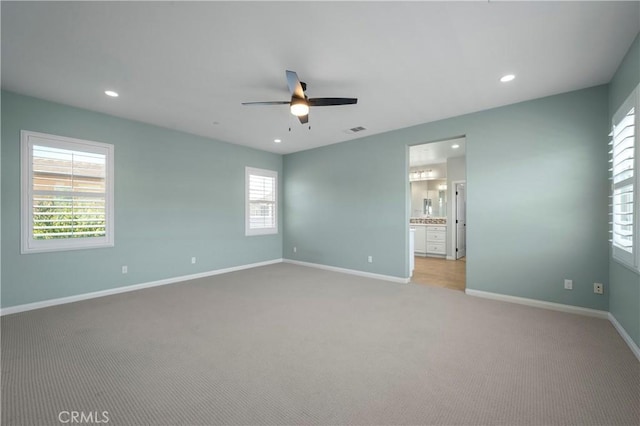 unfurnished bedroom featuring light colored carpet, recessed lighting, and baseboards