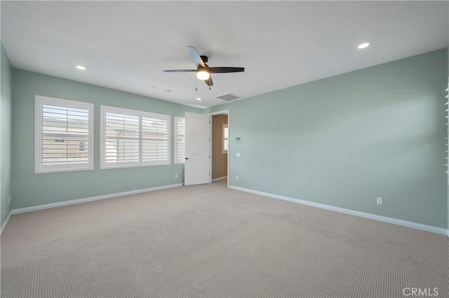 empty room with visible vents, baseboards, and ceiling fan