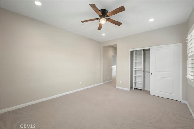 unfurnished bedroom with light colored carpet, recessed lighting, and baseboards