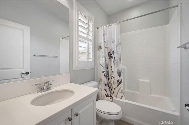 bathroom with vanity, toilet, and shower / bath combo with shower curtain