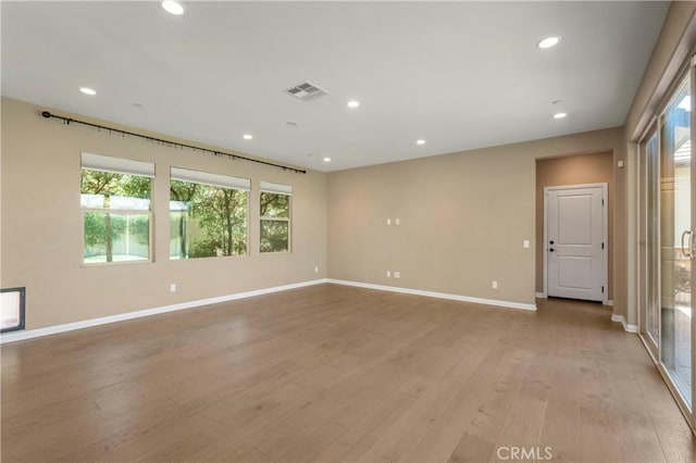spare room featuring visible vents, recessed lighting, baseboards, and light wood-style floors
