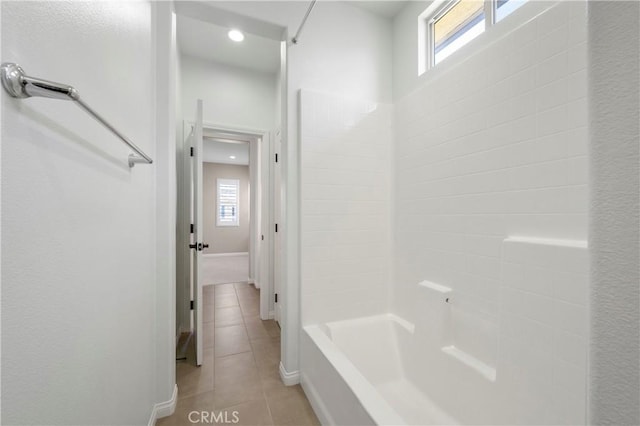 full bath featuring tile patterned flooring, baseboards, a healthy amount of sunlight, and shower / washtub combination