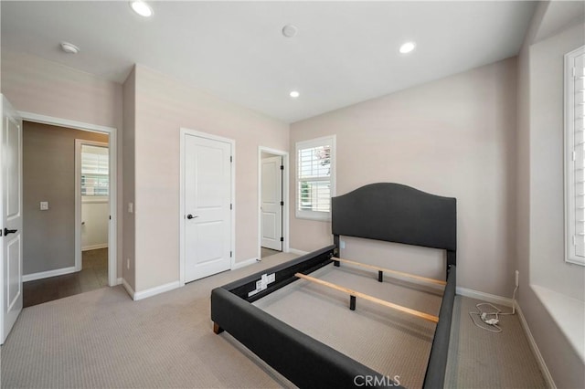 carpeted bedroom with baseboards and recessed lighting