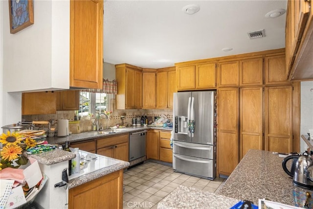 9712 Russell Ave, Garden Grove, CA 92844 - kitchen featuring appliances with stainless steel finishes, decorative backsplash, brown cabinetry, and a sink