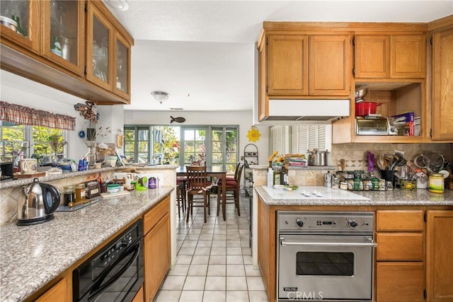 9712 Russell Ave, Garden Grove, CA 92844 - kitchen featuring stainless steel oven, backsplash, light tile patterned floors, and brown cabinets