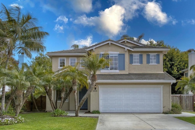 view of front of property featuring fence, a front yard, stucco siding, concrete driveway, and an attached garage