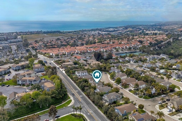 drone / aerial view featuring a water view and a residential view