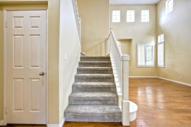 stairway with baseboards and wood-type flooring