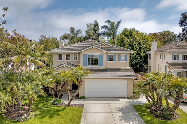 traditional home with a garage, stucco siding, a chimney, and concrete driveway