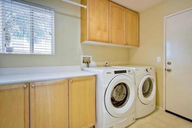 washroom featuring cabinet space and washing machine and clothes dryer