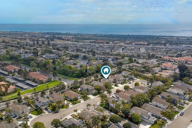 drone / aerial view featuring a water view and a residential view