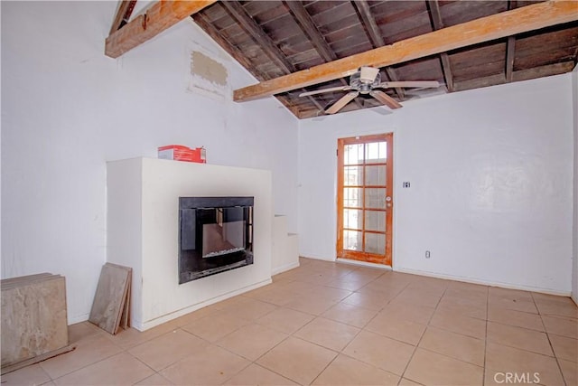 66365 5th St, Desert Hot Springs, CA 92240 - unfurnished living room featuring a glass covered fireplace, tile patterned flooring, vaulted ceiling with beams, and a ceiling fan