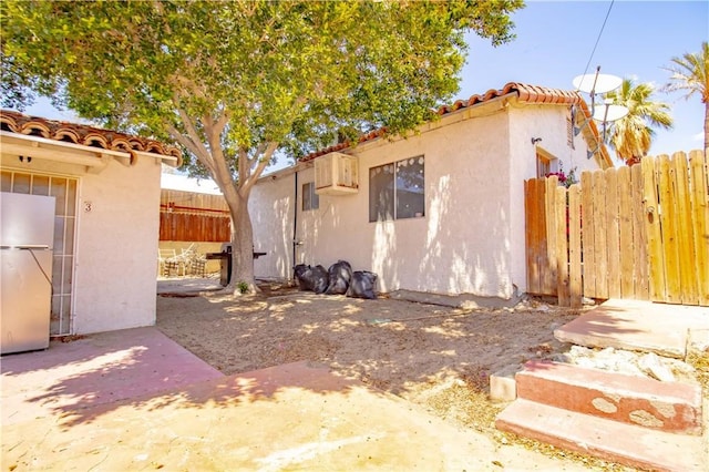 66365 5th St, Desert Hot Springs, CA 92240 - exterior space featuring fence, a tiled roof, a patio area, and stucco siding