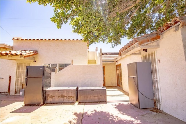 66365 5th St, Desert Hot Springs, CA 92240 - view of front of house with a tiled roof and stucco siding