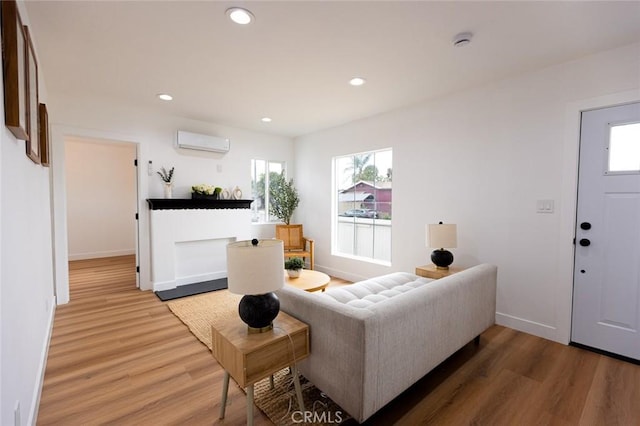 11714 S Spring St, Los Angeles, CA 90061 - living area with recessed lighting, plenty of natural light, light wood-style flooring, and a wall unit AC
