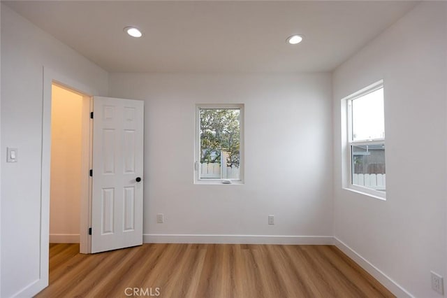 11714 S Spring St, Los Angeles, CA 90061 - spare room featuring recessed lighting, baseboards, and light wood-style flooring
