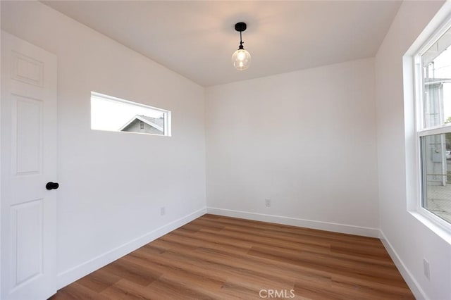 11714 S Spring St, Los Angeles, CA 90061 - spare room featuring baseboards and light wood-style flooring