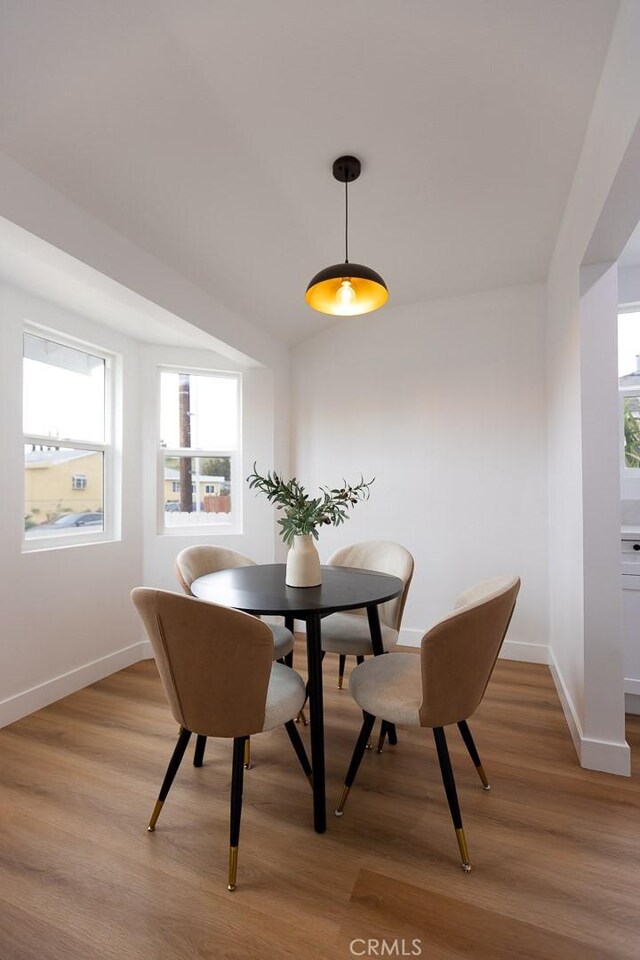 11714 S Spring St, Los Angeles, CA 90061 - dining space with baseboards and light wood-style floors
