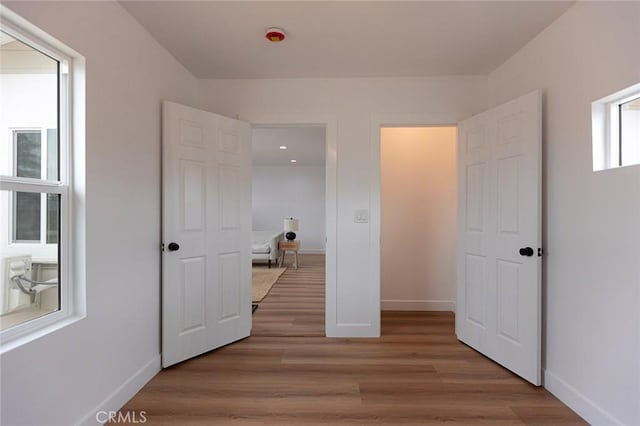 11714 S Spring St, Los Angeles, CA 90061 - unfurnished bedroom featuring baseboards and wood finished floors