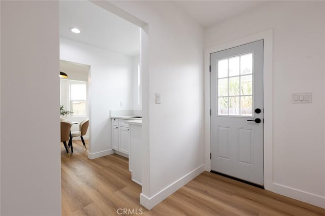 11714 S Spring St, Los Angeles, CA 90061 - doorway featuring baseboards, recessed lighting, and light wood finished floors